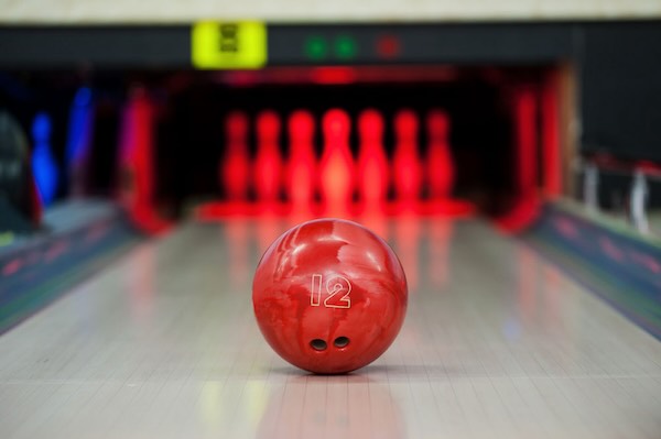 a photo of a bowling ball approaching bowling pins