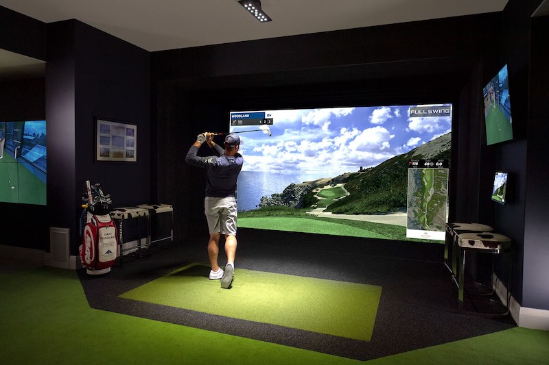 a man playing golf in a virtual golf course